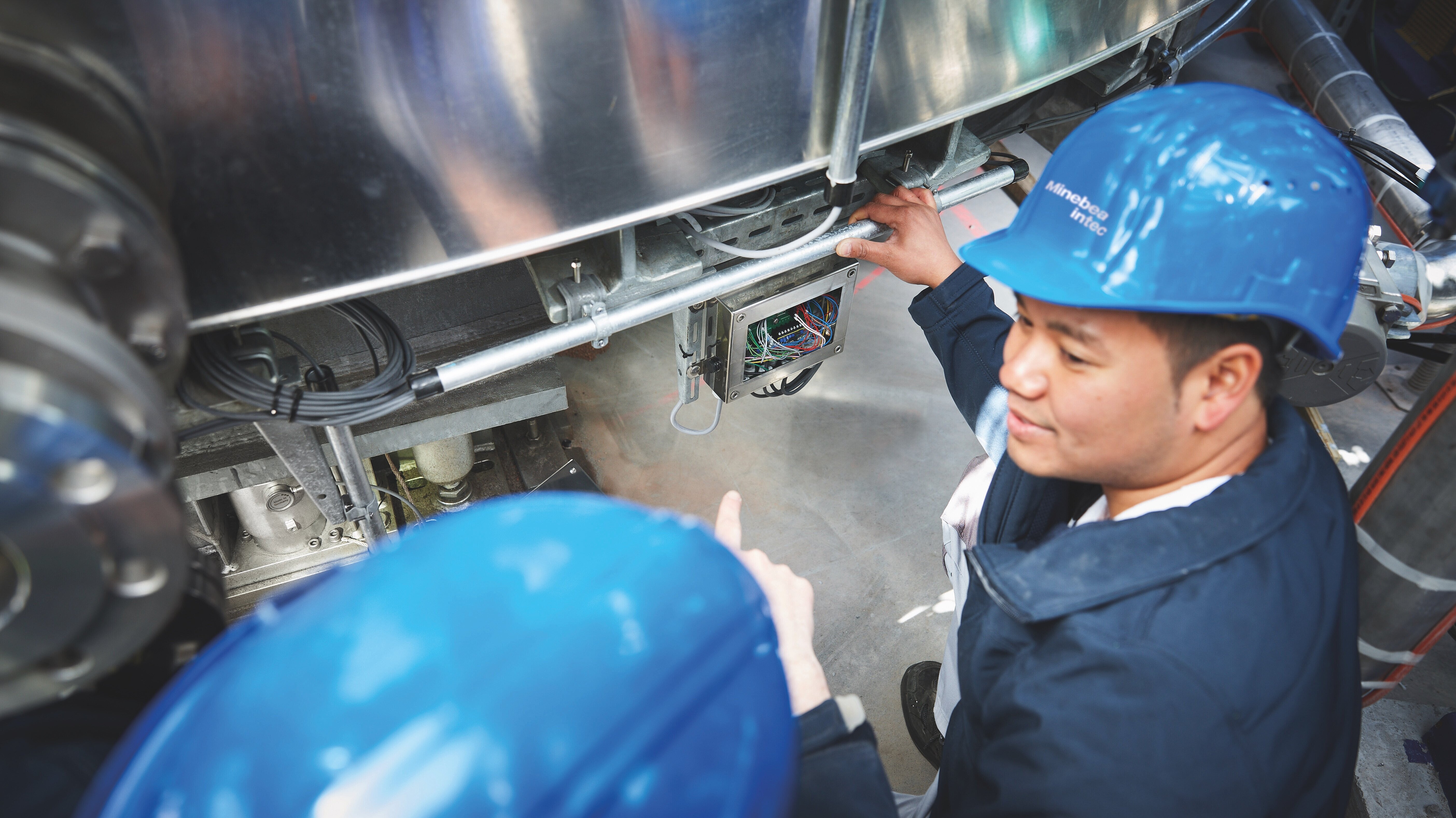 Two technicians investigating a machine